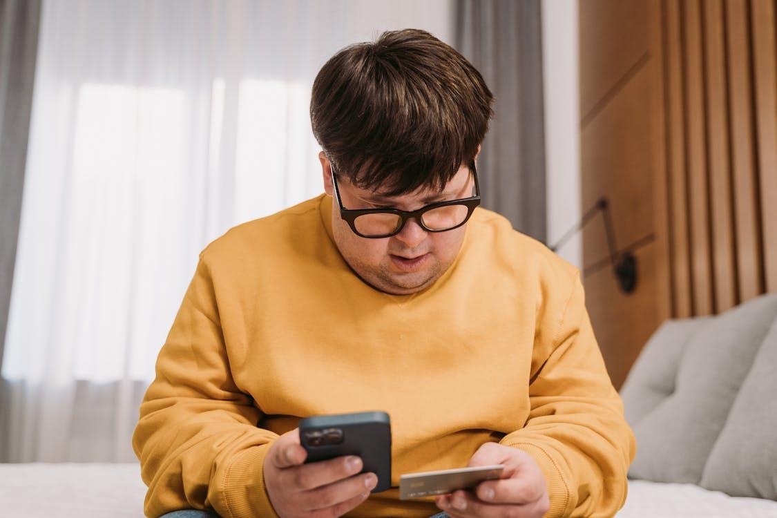 A man is shopping online via a credit card