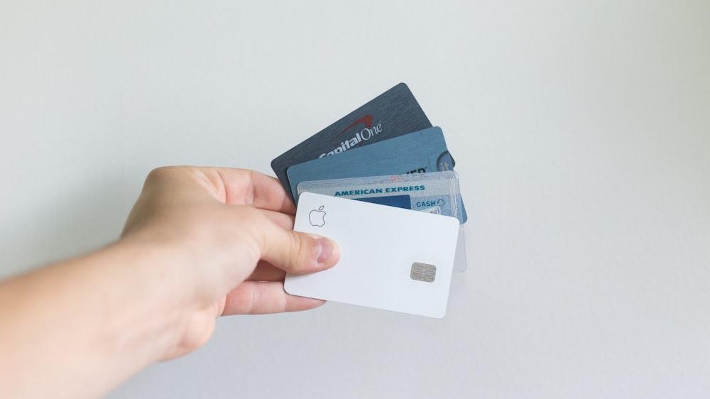 A person holding multiple credit cards