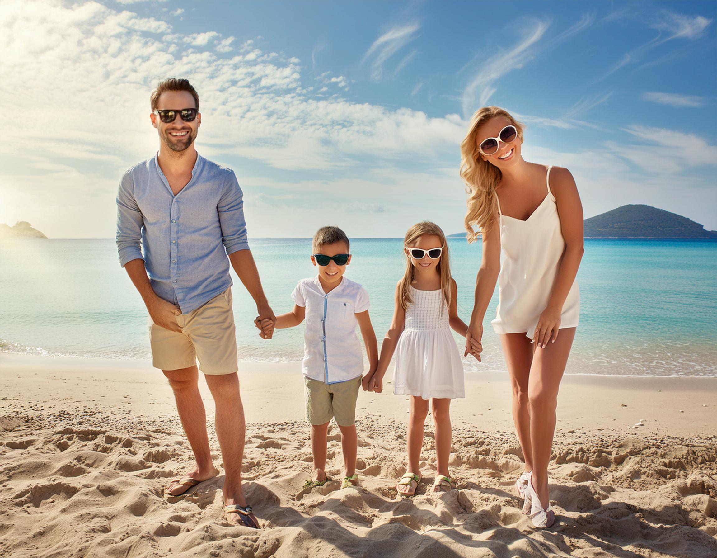 family of 4 on a sandy beach