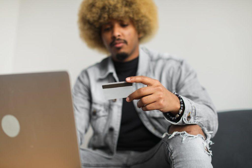 a person is looking at a credit card. 